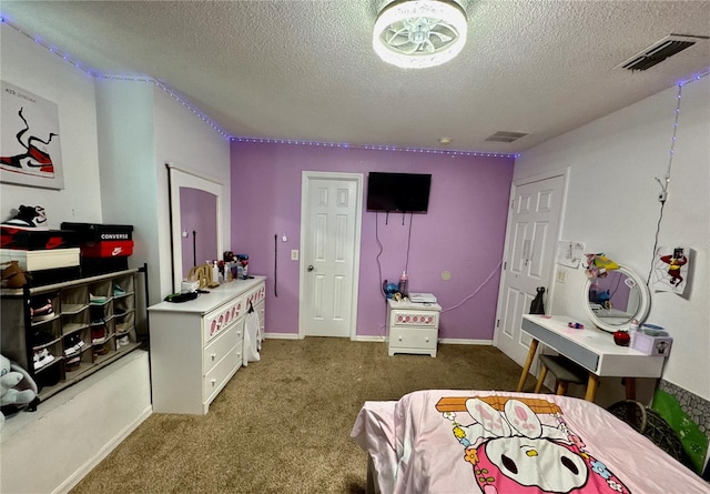 carpeted bedroom with a textured ceiling