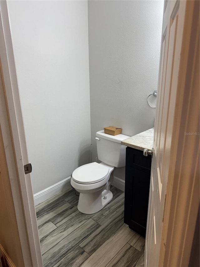 bathroom featuring hardwood / wood-style floors, vanity, and toilet