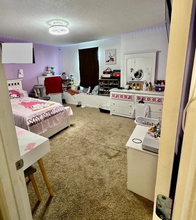 carpeted bedroom featuring a textured ceiling