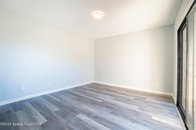 spare room with hardwood / wood-style flooring