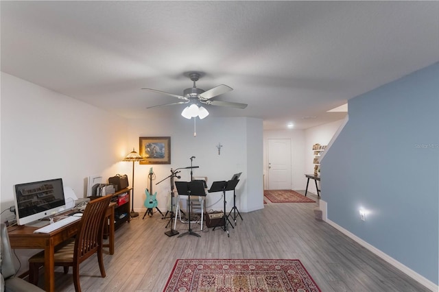 office with light hardwood / wood-style floors and ceiling fan