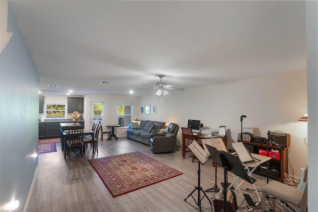 living room with wood-type flooring and ceiling fan