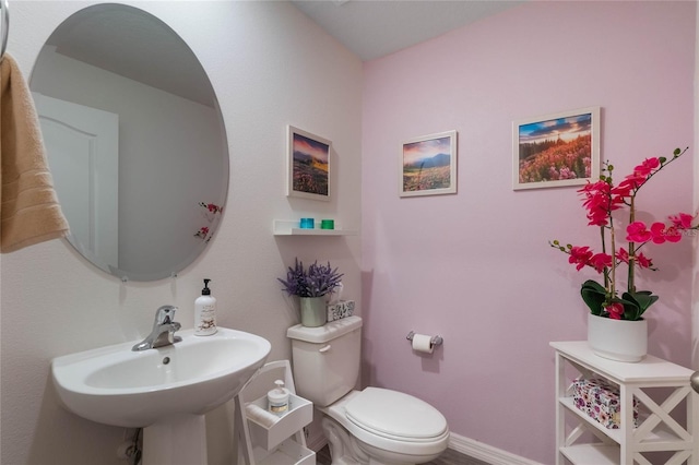 bathroom featuring sink and toilet