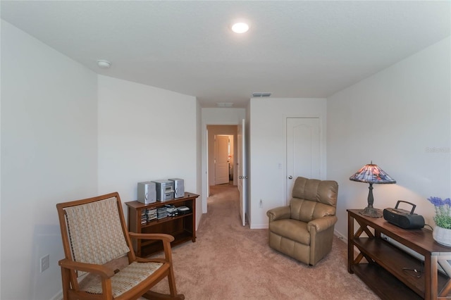 sitting room with light colored carpet