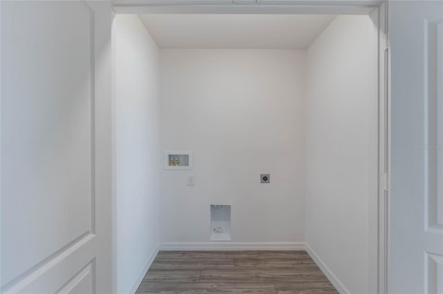 clothes washing area featuring electric dryer hookup, hookup for a washing machine, and dark wood-type flooring