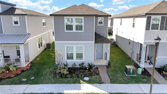 exterior space with a front lawn and central AC unit