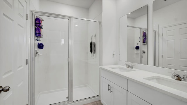 bathroom with an enclosed shower and vanity