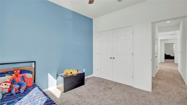 bedroom featuring ceiling fan, a closet, and light carpet