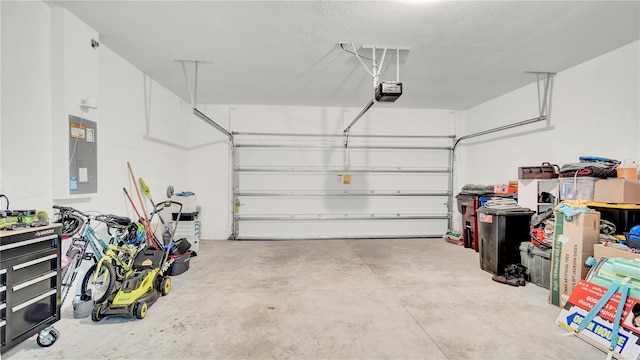 garage with electric panel and a garage door opener