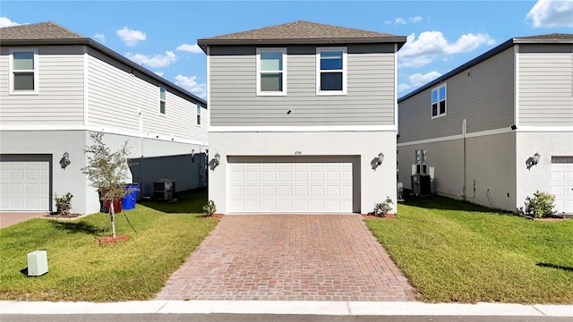 view of property with central air condition unit, a front lawn, and a garage