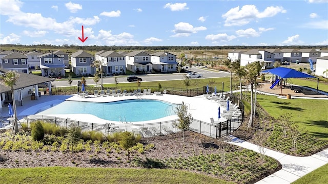 view of swimming pool with a patio and a playground