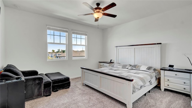 bedroom with ceiling fan and light colored carpet