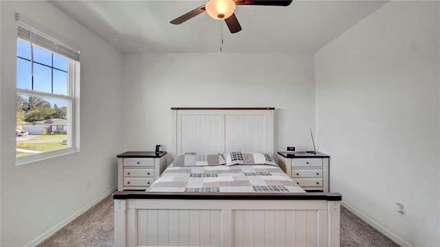 bedroom with ceiling fan and light carpet