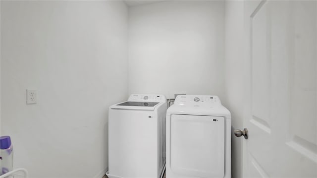 clothes washing area featuring washer and clothes dryer