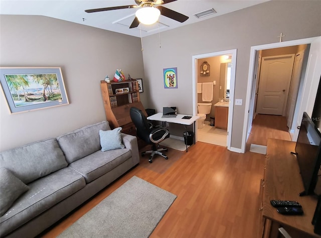 office space featuring ceiling fan, light hardwood / wood-style flooring, and lofted ceiling