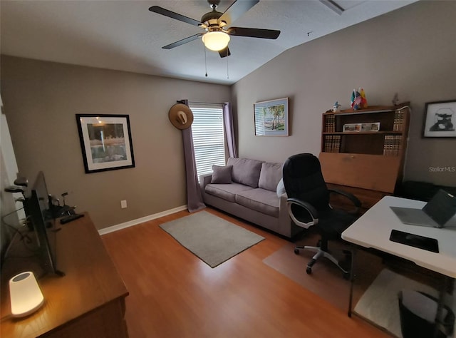 office area with light wood-type flooring, vaulted ceiling, and ceiling fan