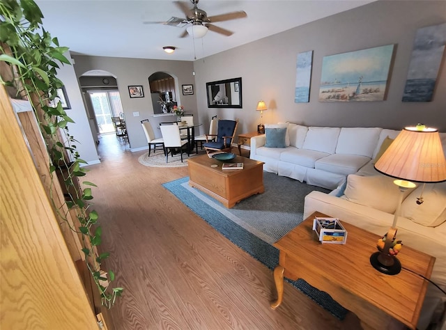 living room featuring ceiling fan and hardwood / wood-style flooring