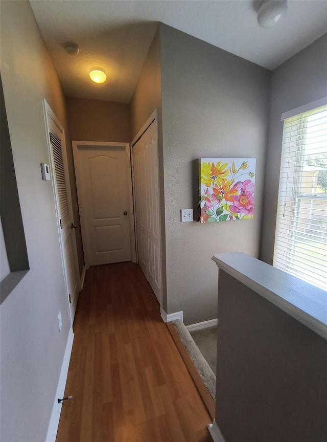 corridor with hardwood / wood-style floors