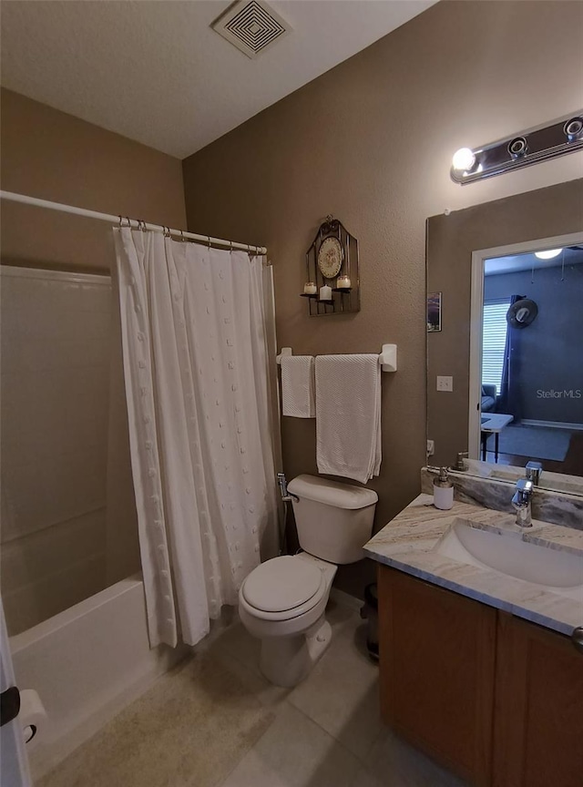 full bathroom featuring tile patterned floors, vanity, toilet, and shower / bath combo with shower curtain