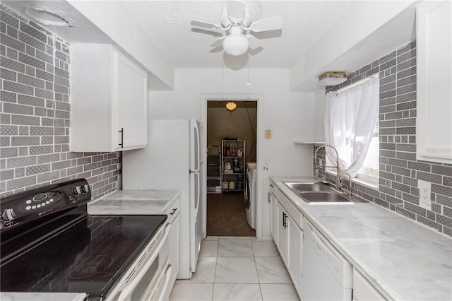 kitchen with white dishwasher, white cabinets, sink, a textured ceiling, and black / electric stove