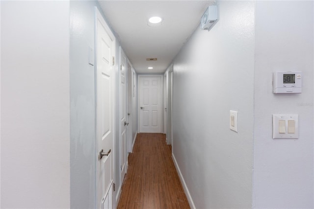 hallway with hardwood / wood-style flooring