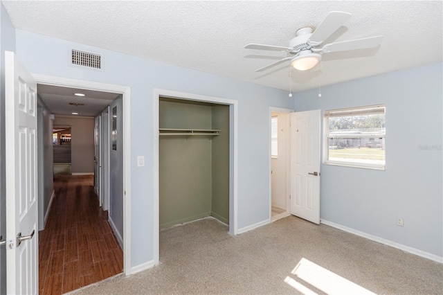 unfurnished bedroom with a textured ceiling, a closet, and ceiling fan