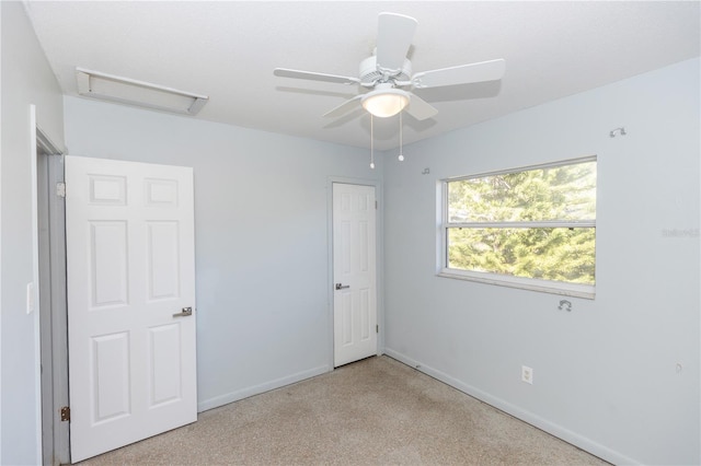 carpeted empty room featuring ceiling fan