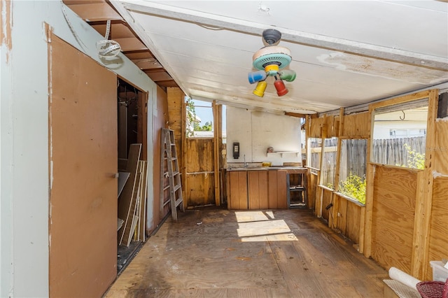 miscellaneous room featuring dark wood-type flooring and lofted ceiling