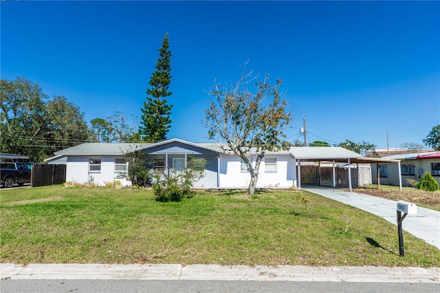 ranch-style house featuring a carport and a front yard