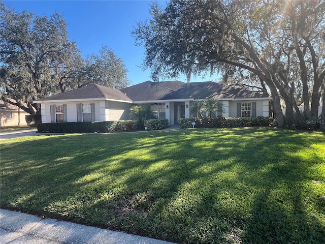 single story home featuring a front lawn