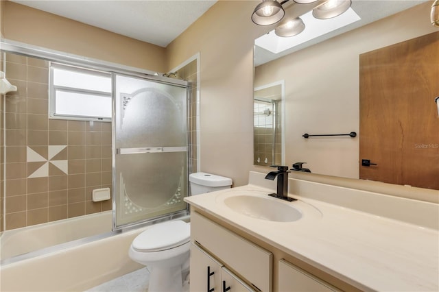 full bathroom with shower / bath combination with glass door, tile patterned floors, vanity, and toilet