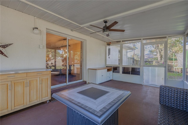 sunroom / solarium featuring ceiling fan