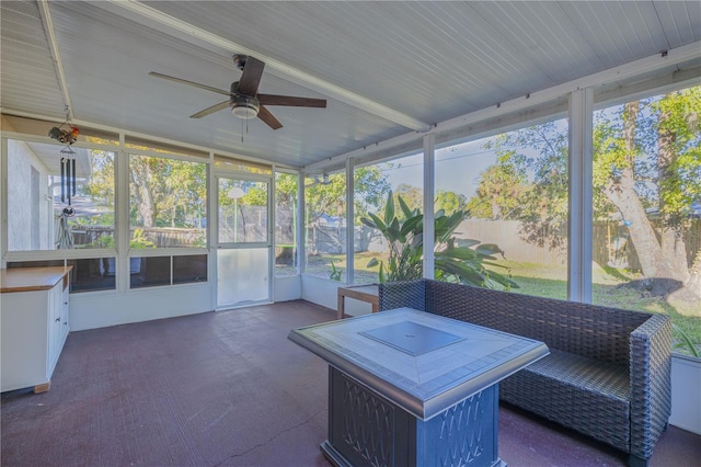 unfurnished sunroom with vaulted ceiling, plenty of natural light, and ceiling fan