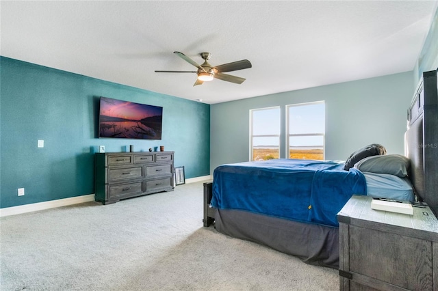 bedroom featuring ceiling fan and light carpet