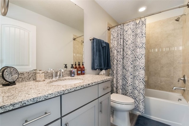 full bathroom featuring vanity, shower / bath combo, and toilet