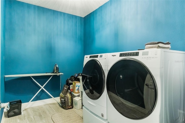 laundry area featuring washer and dryer and wood-type flooring