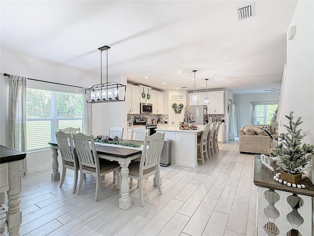 dining area featuring light wood-type flooring