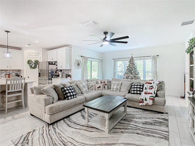 living room featuring ceiling fan and light hardwood / wood-style flooring