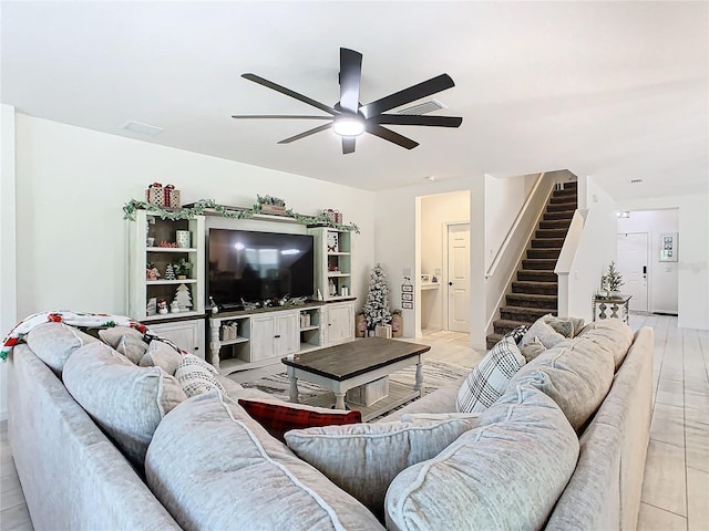 living room featuring light tile patterned floors and ceiling fan