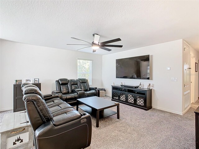 living room with light carpet, a textured ceiling, and ceiling fan