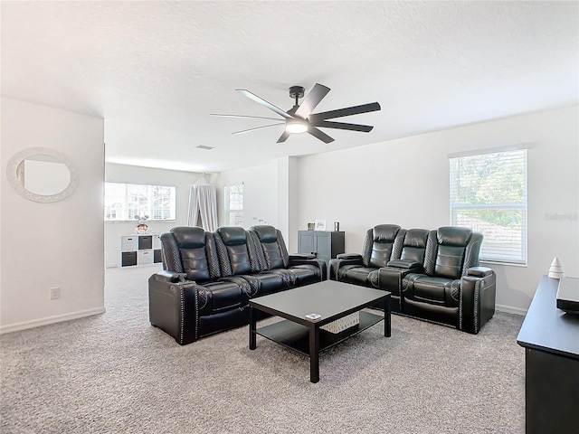 carpeted living room with plenty of natural light, ceiling fan, and a textured ceiling