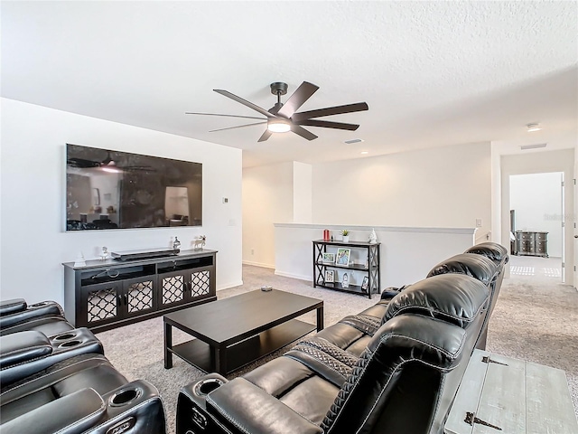 carpeted living room featuring a textured ceiling and ceiling fan