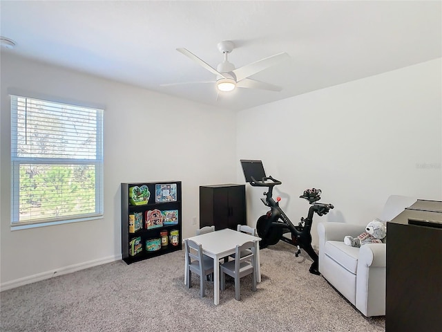 rec room featuring light carpet and ceiling fan