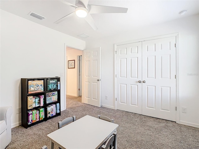 office space with light carpet and ceiling fan