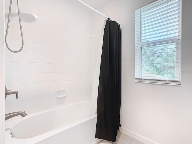 bathroom featuring tile patterned floors, a wealth of natural light, and shower / bath combination with curtain