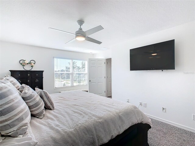 bedroom featuring ceiling fan and carpet