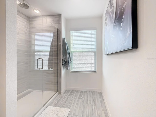 bathroom with a shower with shower door