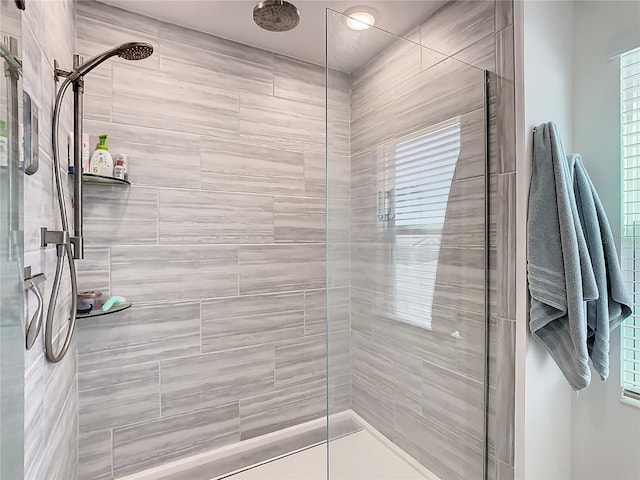 bathroom with a tile shower