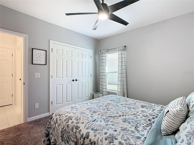 bedroom featuring ceiling fan, light carpet, and a closet