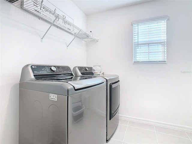 laundry room with light tile patterned flooring and separate washer and dryer